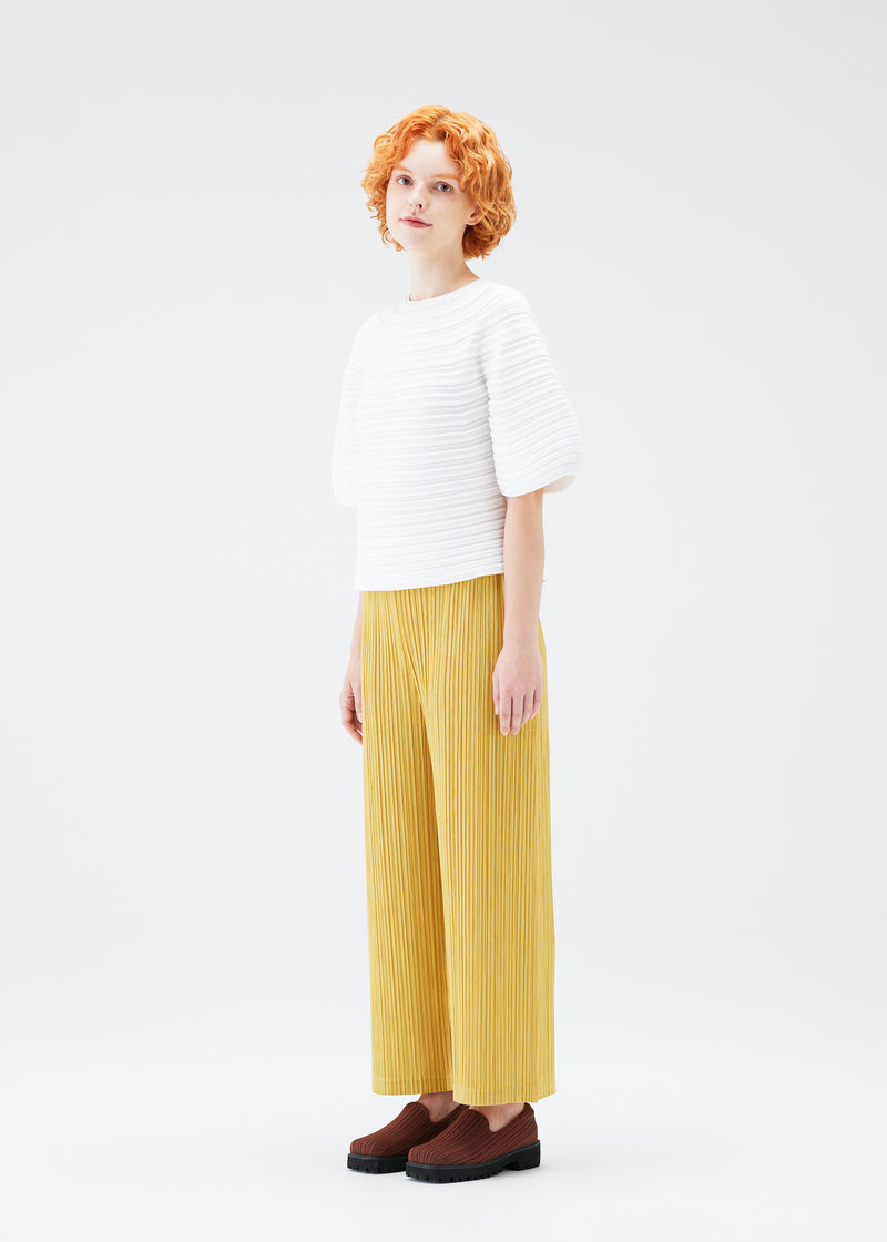 A model wears the PLEATS PLEASE ISSEY MIYAKE  MUSHROOM KNIT top