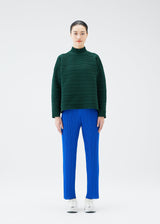 A model wears the PLEATS PLEASE ISSEY MIYAKE CREPE KNIT top.