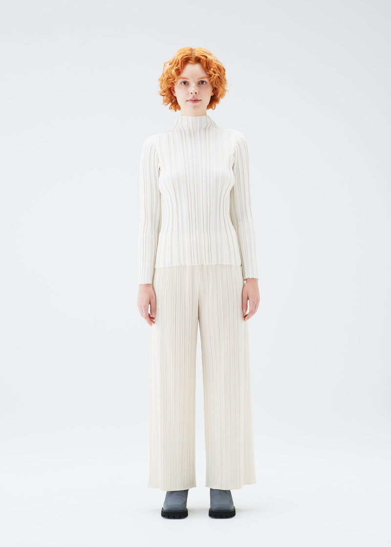 A model wears the PLEATS PLEASE ISSEY MIYAKE PLANET KNIT top.