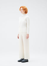 A model wears the PLEATS PLEASE ISSEY MIYAKE PLANET KNIT top.