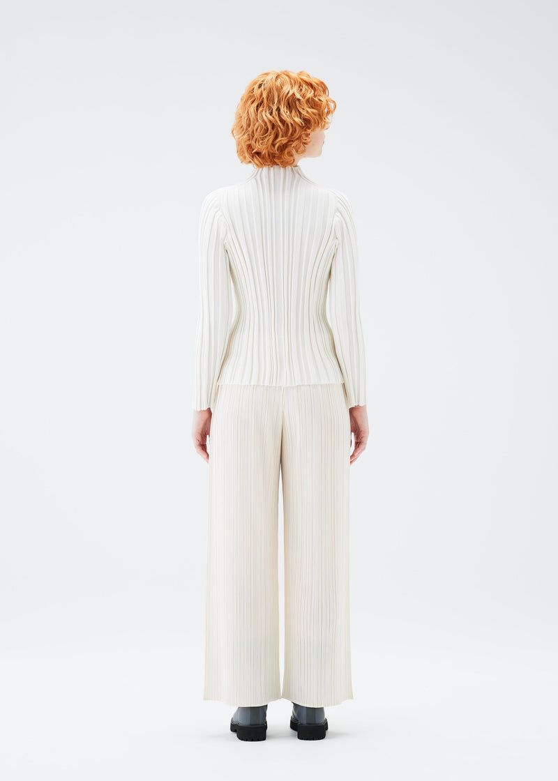 A model wears the PLEATS PLEASE ISSEY MIYAKE PLANET KNIT top.