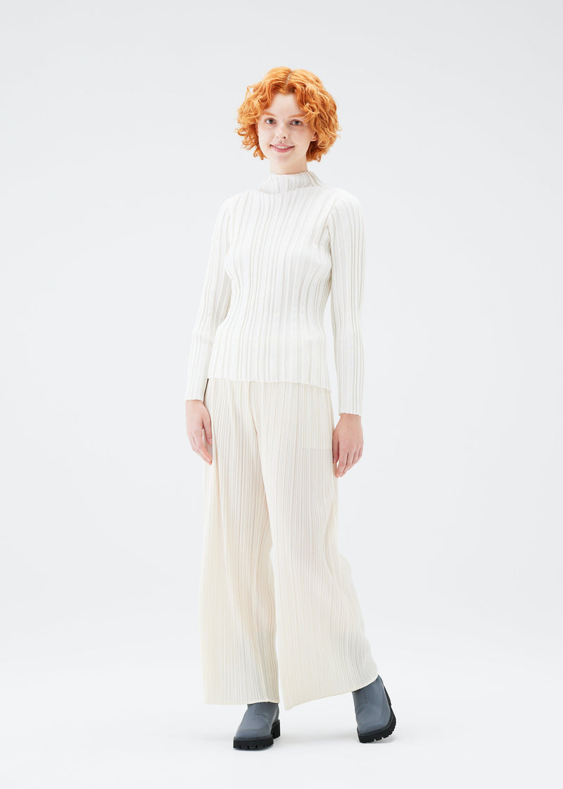 A model wears the PLEATS PLEASE ISSEY MIYAKE PLANET KNIT top.