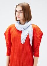 A model wears the PLEATS PLEASE ISSEY MIYAKE  MONTHLY SCARF JULY stole