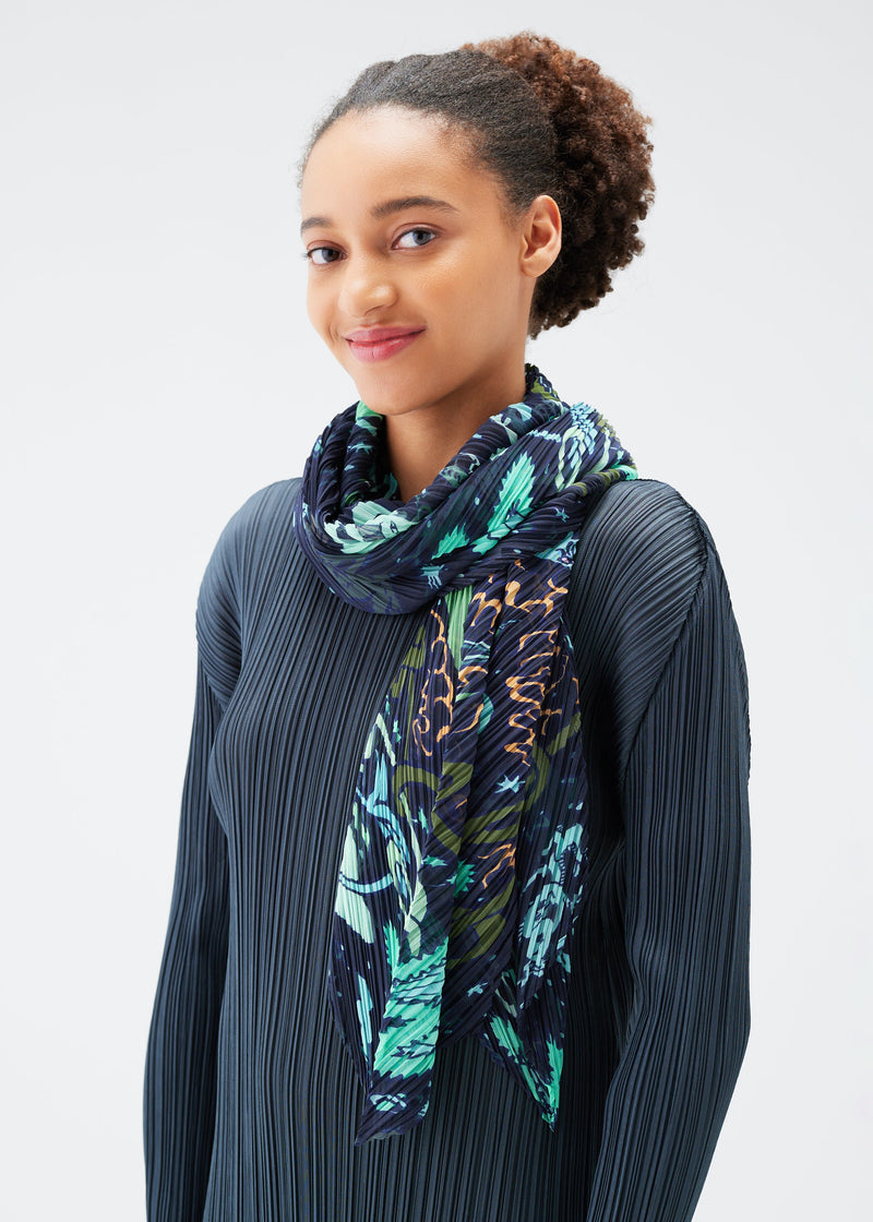 A model wears the PLEATS PLEASE ISSEY MIYAKE INTERPLANETARY SCARF stole.