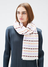 A model wears the PLEATS PLEASE ISSEY MIYAKE STARDUST SCARF stole.