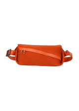 A product shot of the PLEATS PLEASE ISSEY MIYAKE  BIAS PLEATS WAISTBAG bag in dark orange (33)