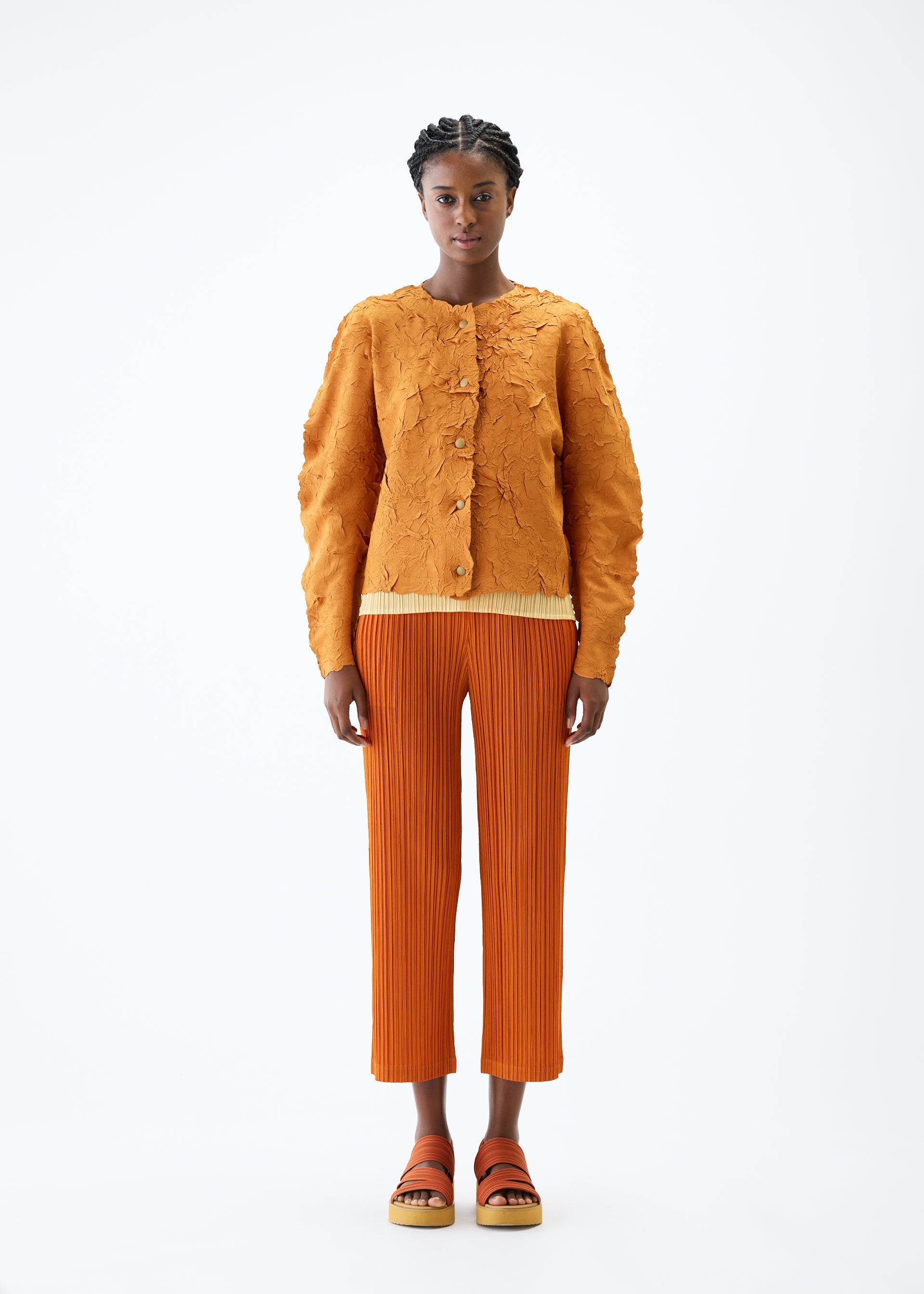 A model wears the PLEATS PLEASE ISSEY MIYAKE CRUSH PRESS jacket.