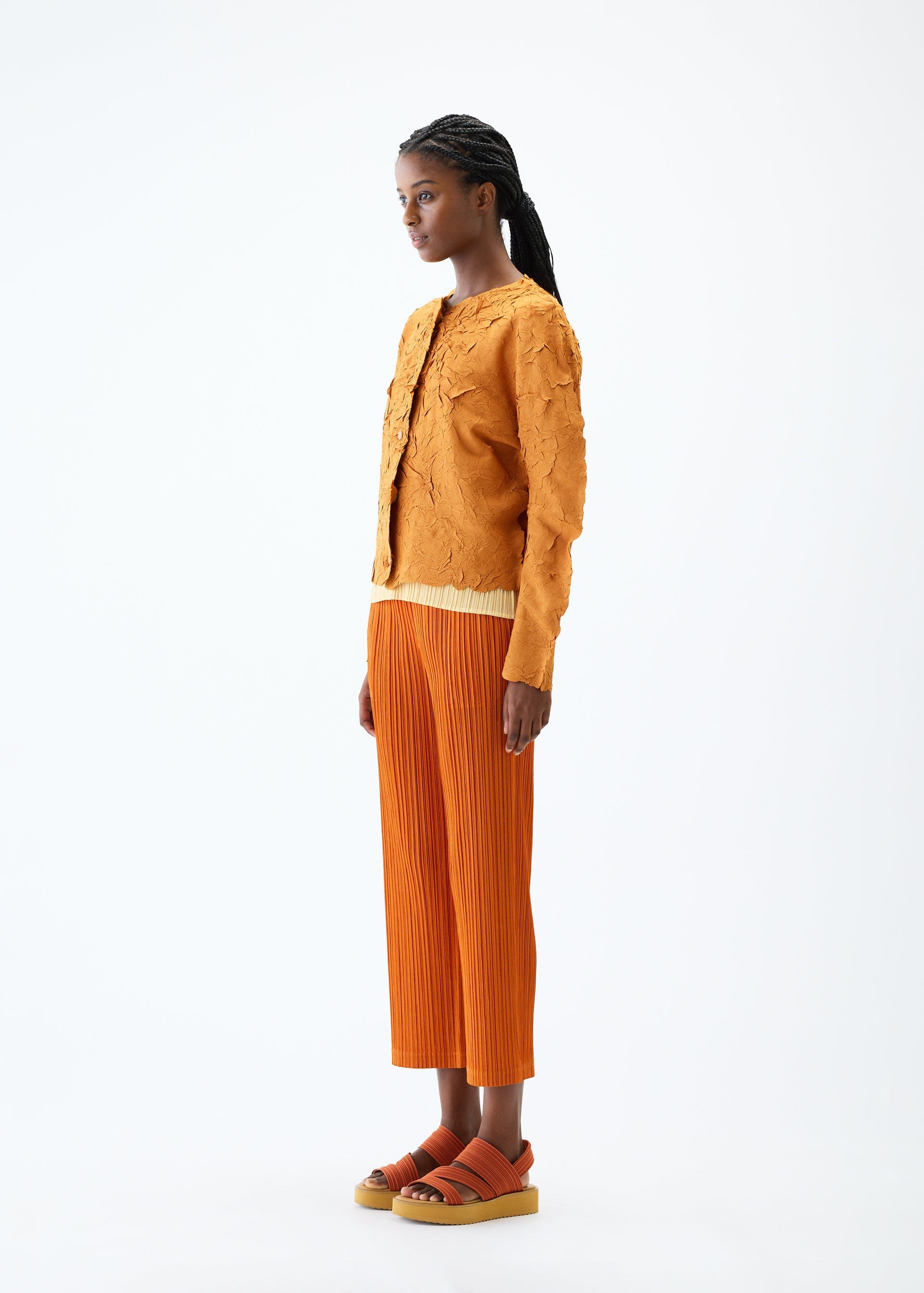 A model wears the PLEATS PLEASE ISSEY MIYAKE CRUSH PRESS jacket.