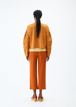A model wears the PLEATS PLEASE ISSEY MIYAKE CRUSH PRESS jacket.