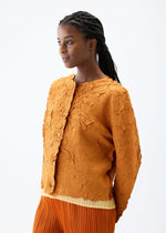 A model wears the PLEATS PLEASE ISSEY MIYAKE CRUSH PRESS jacket.