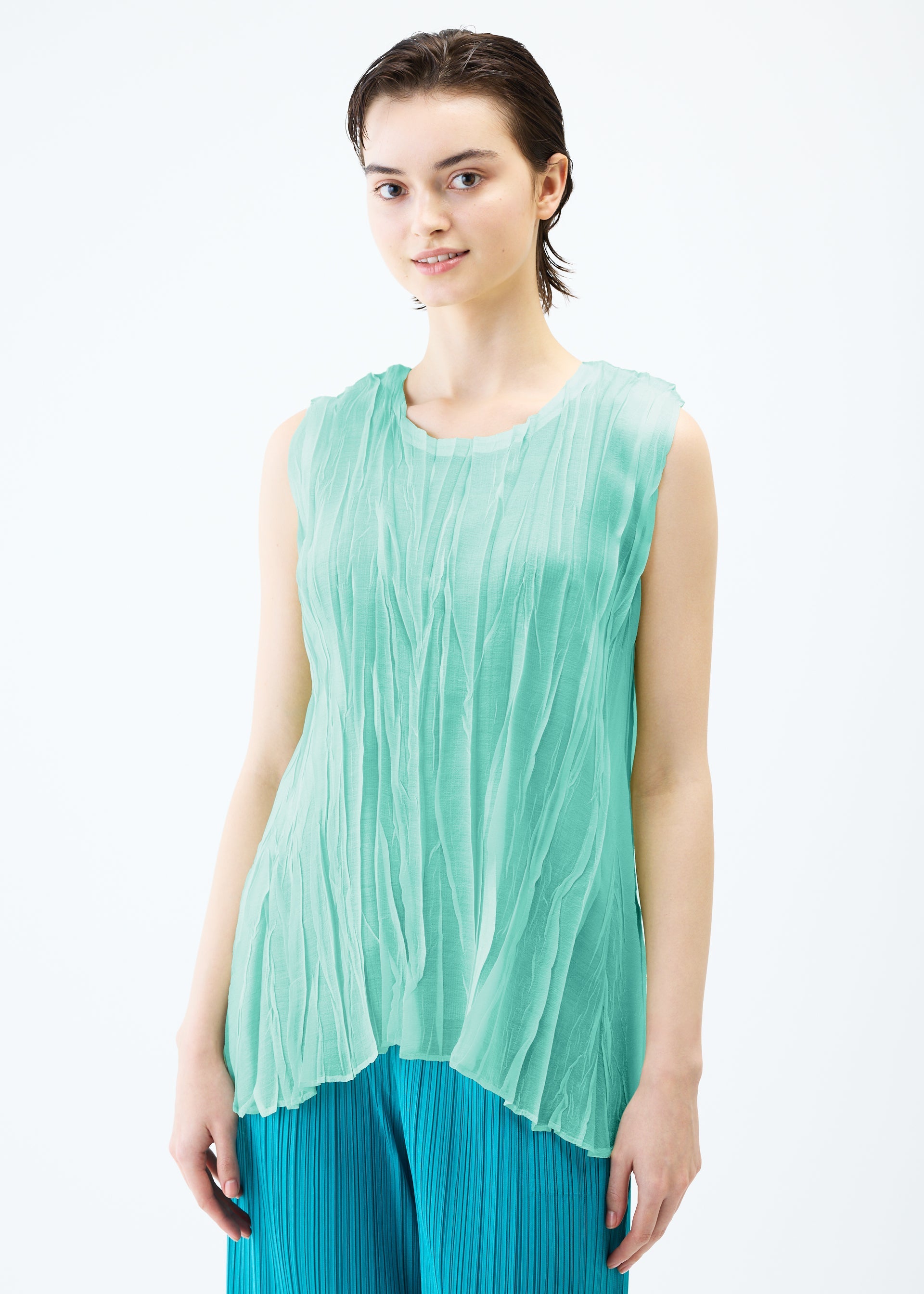 A model wears the PLEATS PLEASE ISSEY MIYAKE SHEER TWIST top.