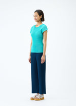 A model wears the PLEATS PLEASE ISSEY MIYAKE MIST APRIL top.