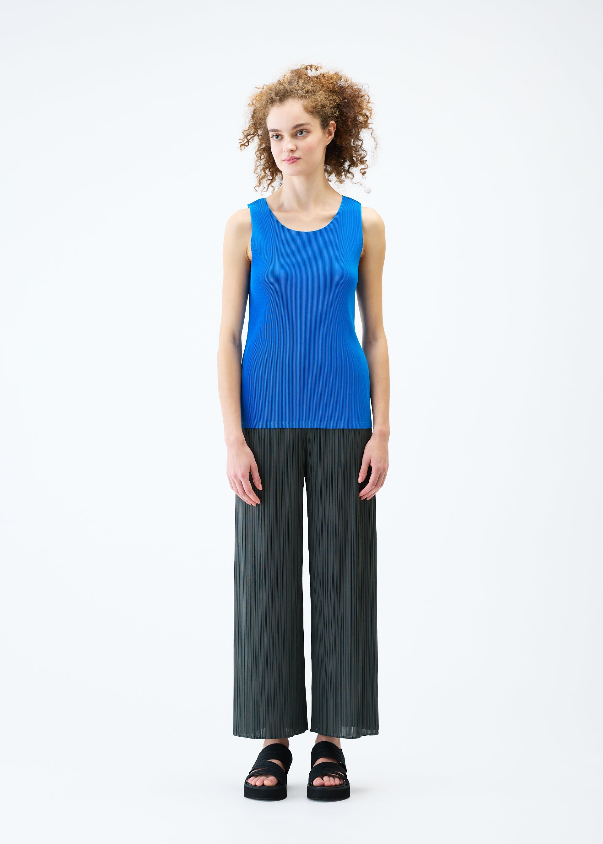 A model wears the PLEATS PLEASE ISSEY MIYAKE MIST JUNE top.