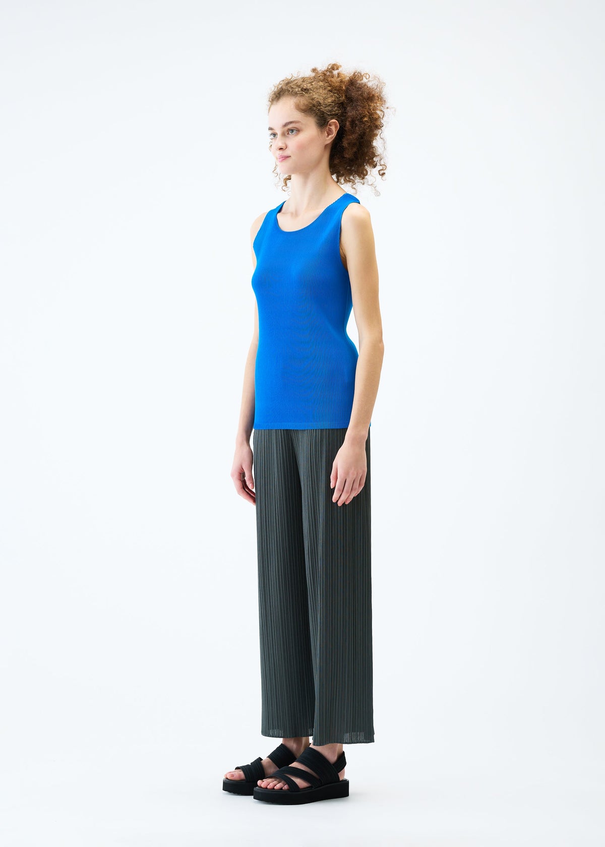 A model wears the PLEATS PLEASE ISSEY MIYAKE MIST JUNE top.