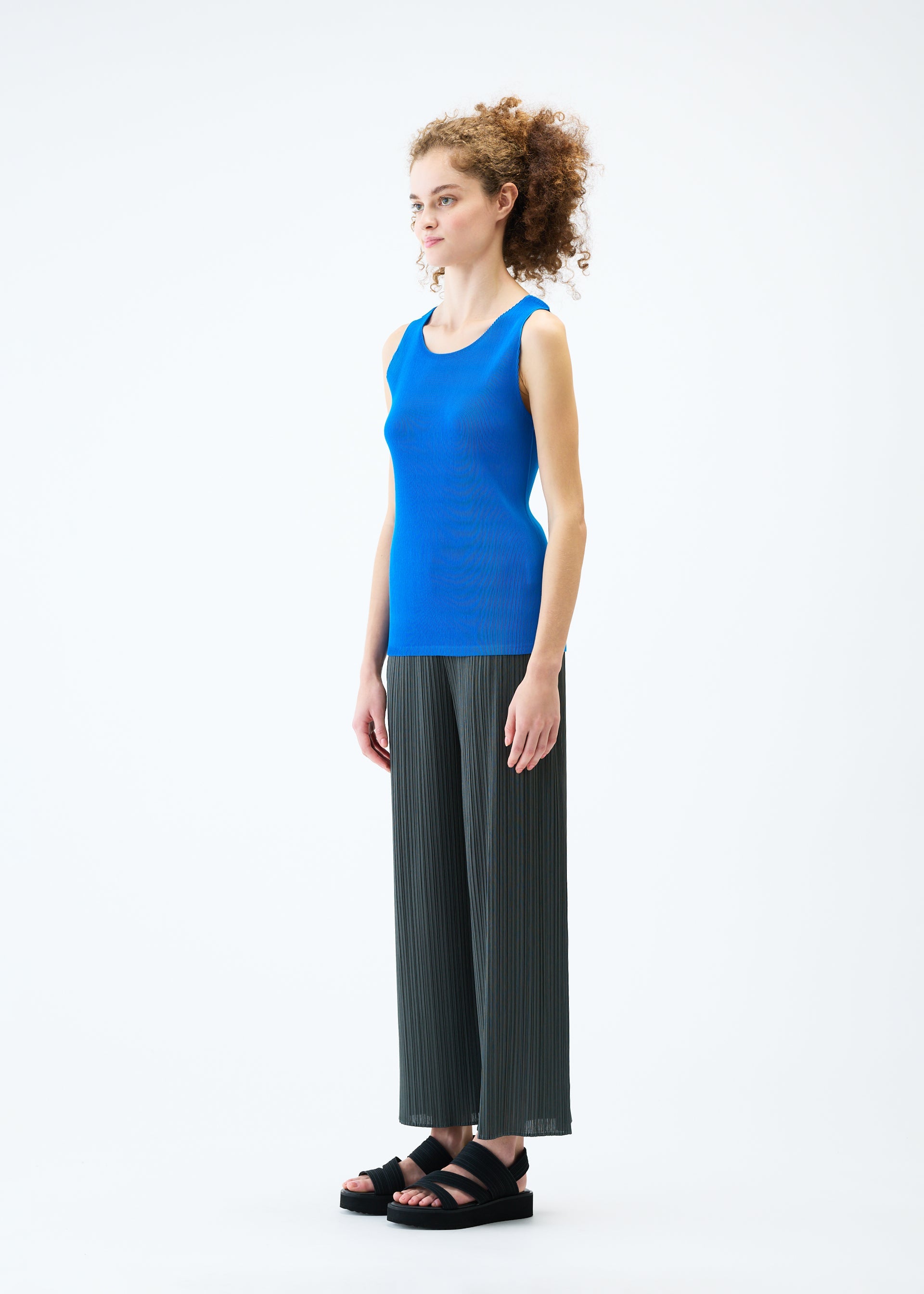A model wears the PLEATS PLEASE ISSEY MIYAKE MIST JUNE top.