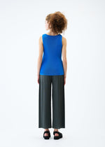 A model wears the PLEATS PLEASE ISSEY MIYAKE MIST JUNE top.