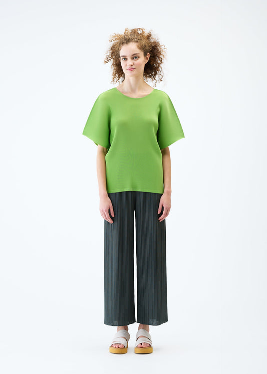 A model wears the PLEATS PLEASE ISSEY MIYAKE MIST JUNE top.