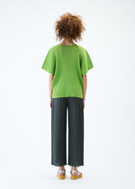 A model wears the PLEATS PLEASE ISSEY MIYAKE MIST JUNE top.