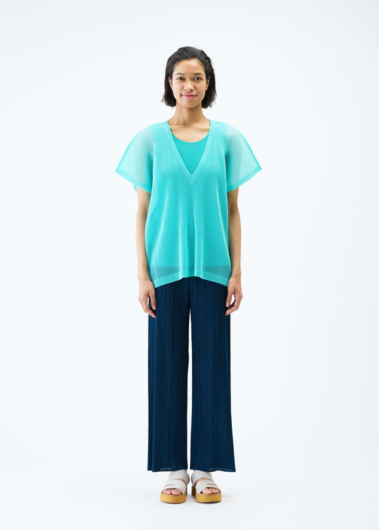 A model wears the PLEATS PLEASE ISSEY MIYAKE TATAMI APRIL top.