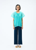 A model wears the PLEATS PLEASE ISSEY MIYAKE TATAMI APRIL top.