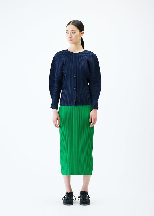 A model wears the PLEATS PLEASE ISSEY MIYAKE RIB PLEATS FEBRUARY cardigan.