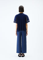 A model wears the PLEATS PLEASE ISSEY MIYAKE SHEER SQUARE cardigan.