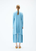 A model wears the PLEATS PLEASE ISSEY MIYAKE MELLOW PLEATS coat.