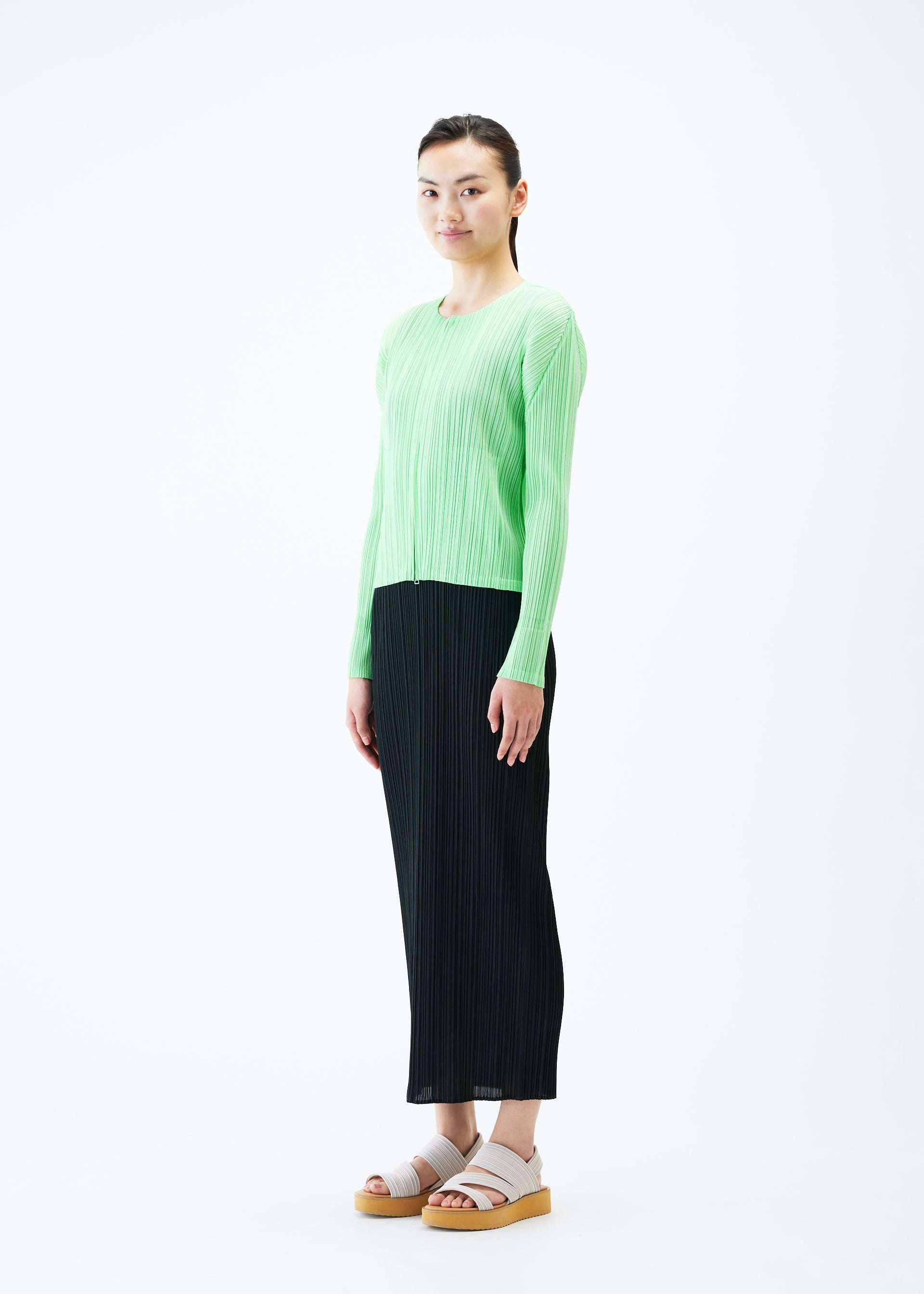 A model wears the PLEATS PLEASE ISSEY MIYAKE MONTHLY COLORS MAY jacket.