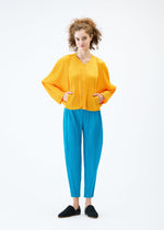 A model wears the PLEATS PLEASE ISSEY MIYAKE LANTERN jacket.
