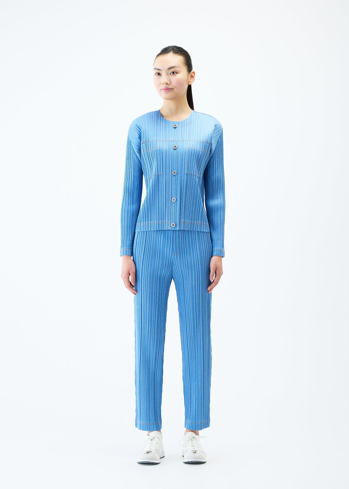 A model wears the PLEATS PLEASE ISSEY MIYAKE COTTON DENIM jacket.