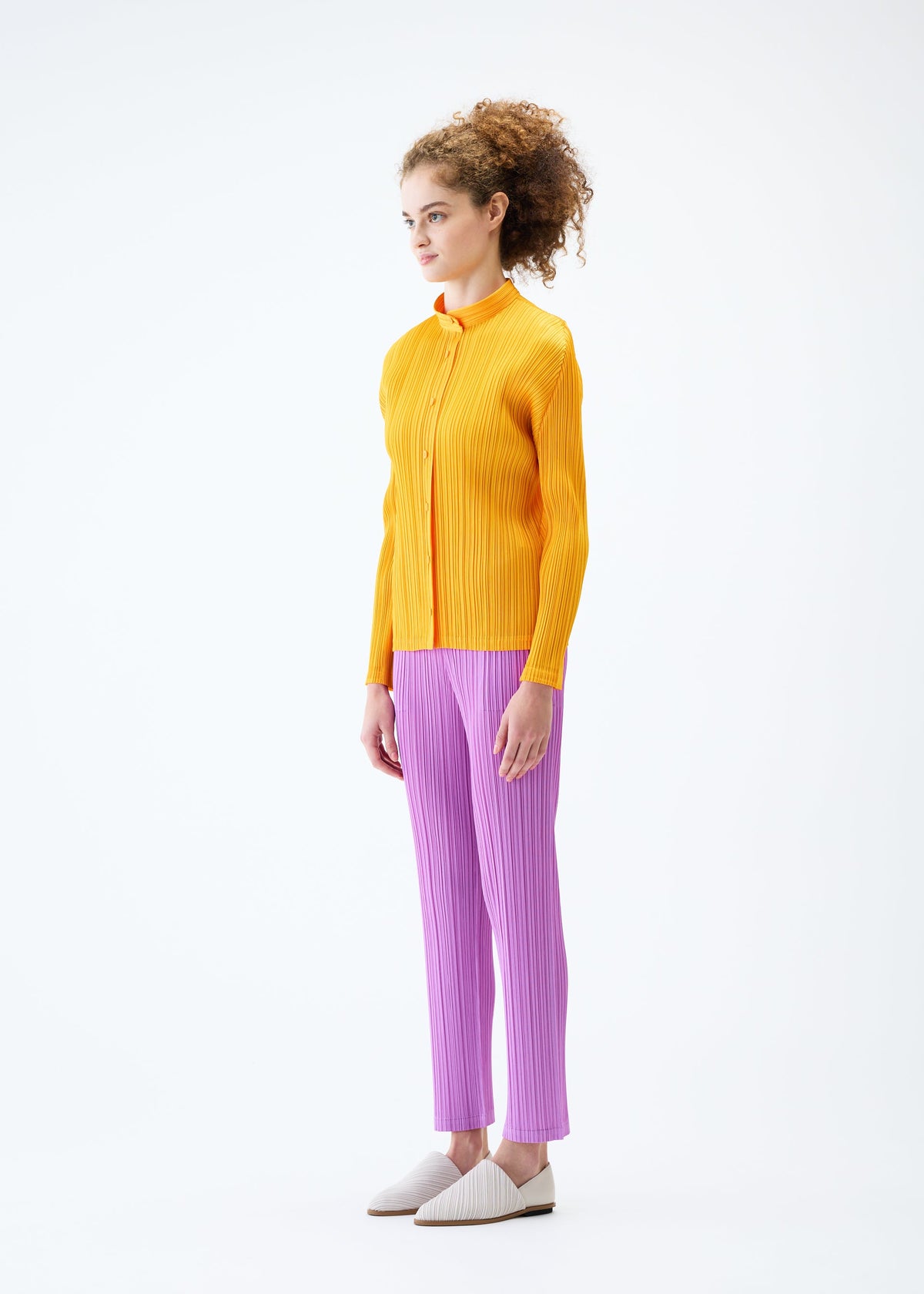 A model wears the PLEATS PLEASE ISSEY MIYAKE MONTHLY COLORS JANUARY trousers.