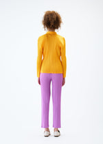 A model wears the PLEATS PLEASE ISSEY MIYAKE MONTHLY COLORS JANUARY trousers.