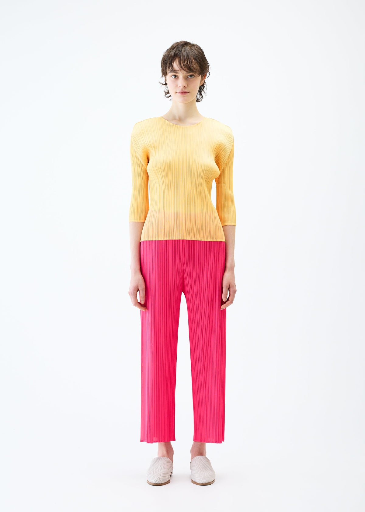 A model wears the PLEATS PLEASE ISSEY MIYAKE MONTHLY COLORS MARCH trousers.