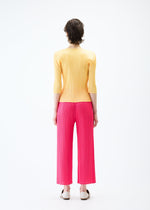 A model wears the PLEATS PLEASE ISSEY MIYAKE MONTHLY COLORS MARCH trousers.