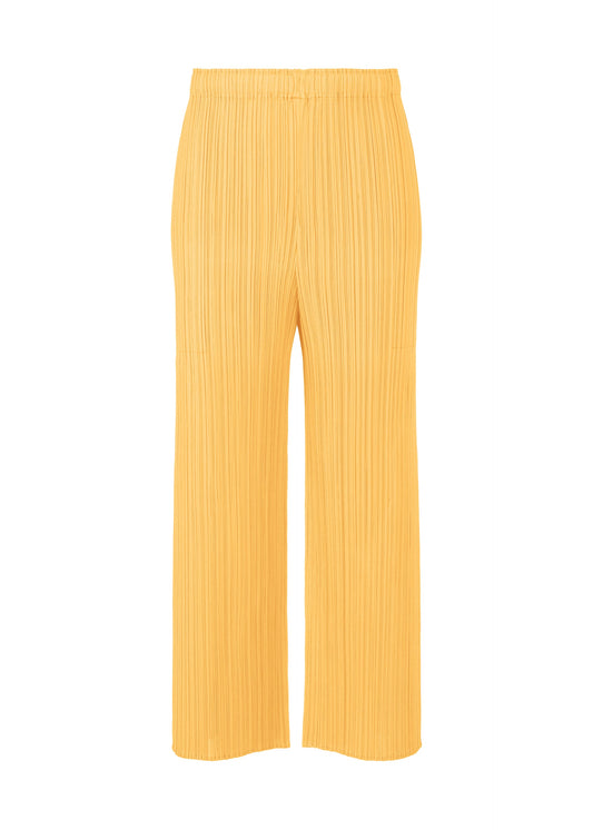 A product shot of the PLEATS PLEASE ISSEY MIYAKE MONTHLY COLORS MARCH trousers in apricot yellow (30).