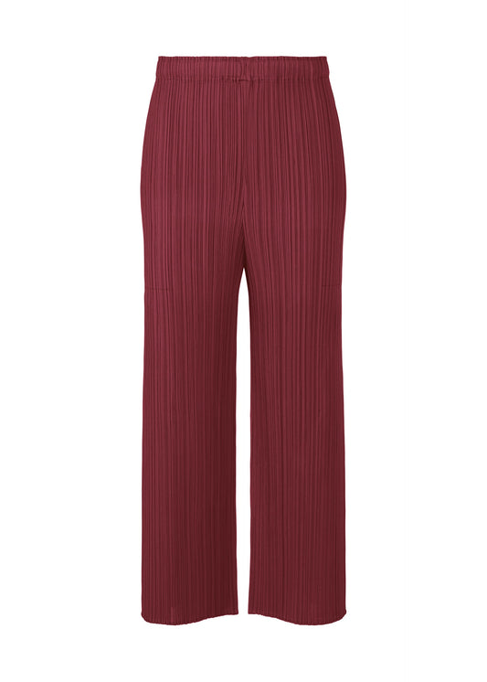 A product shot of the PLEATS PLEASE ISSEY MIYAKE MONTHLY COLORS MARCH trousers in bordeaux (84).