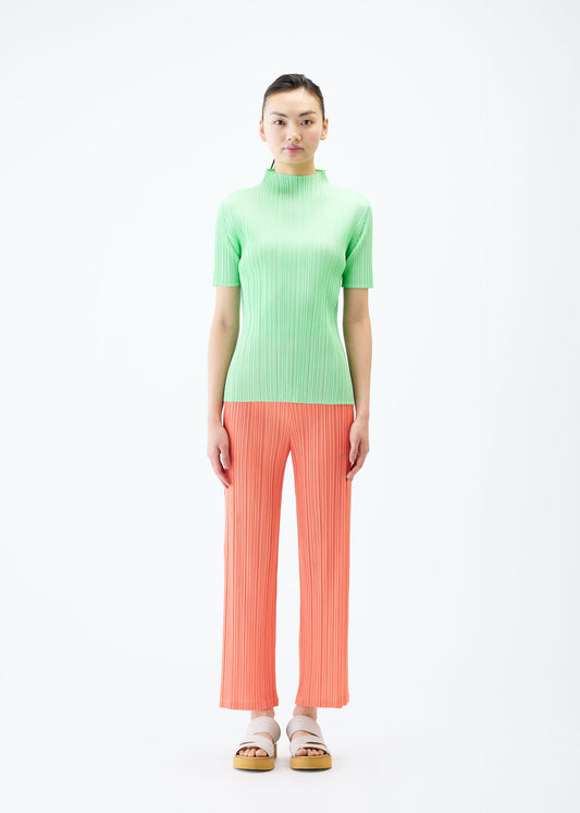 A model wears the PLEATS PLEASE ISSEY MIYAKE MONTHLY COLORS MAY trousers.