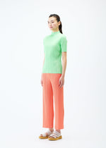 A model wears the PLEATS PLEASE ISSEY MIYAKE MONTHLY COLORS MAY trousers.
