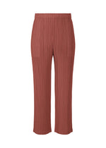 A product shot of the PLEATS PLEASE ISSEY MIYAKE MONTHLY COLORS MAY trousers in terracotta (40).