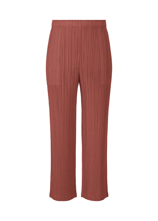A product shot of the PLEATS PLEASE ISSEY MIYAKE MONTHLY COLORS MAY trousers in terracotta (40).