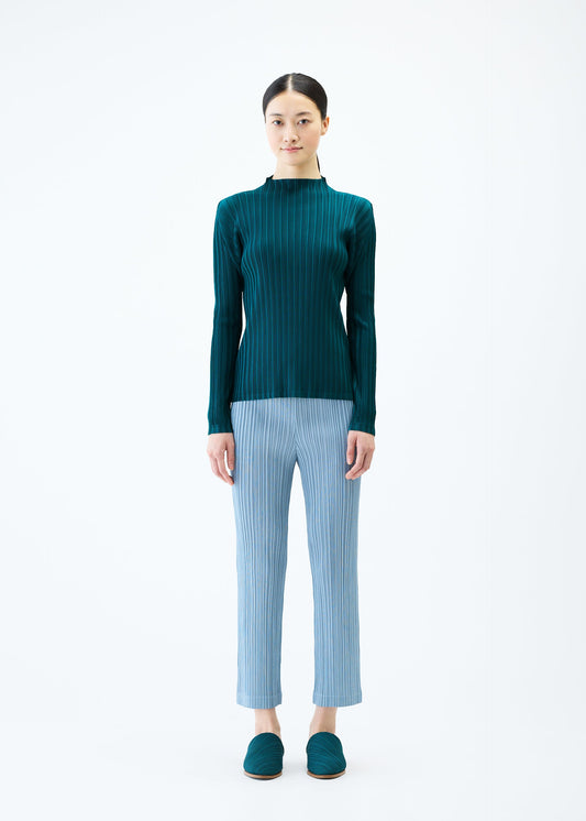 A model wears the PLEATS PLEASE ISSEY MIYAKE THICKER BOTTOMS 1 trousers.