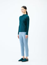 A model wears the PLEATS PLEASE ISSEY MIYAKE THICKER BOTTOMS 1 trousers.