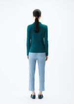 A model wears the PLEATS PLEASE ISSEY MIYAKE THICKER BOTTOMS 1 trousers.