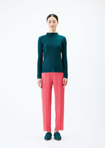 A model wears the PLEATS PLEASE ISSEY MIYAKE THICKER BOTTOMS 1 trousers.