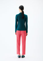 A model wears the PLEATS PLEASE ISSEY MIYAKE THICKER BOTTOMS 1 trousers.