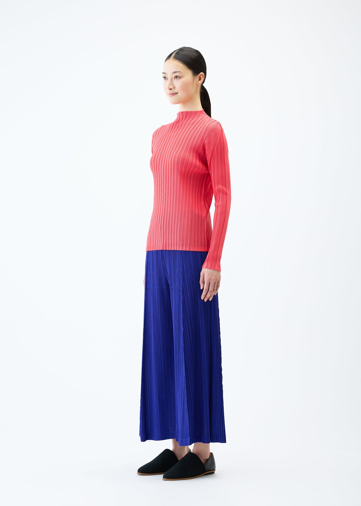 A model wears the PLEATS PLEASE ISSEY MIYAKE THICKER BOTTOMS 1 trousers.