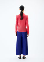 A model wears the PLEATS PLEASE ISSEY MIYAKE THICKER BOTTOMS 1 trousers.