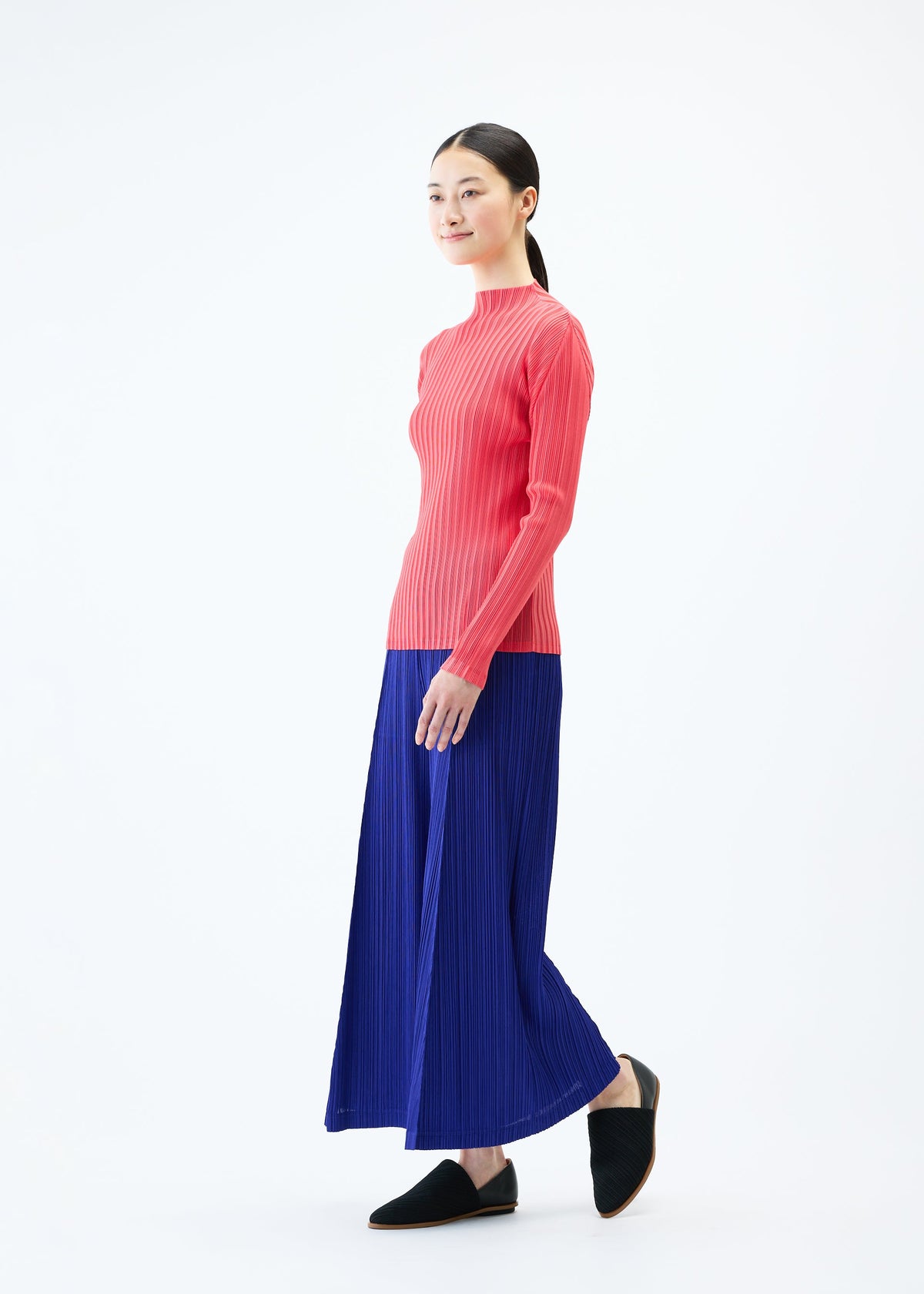 A model wears the PLEATS PLEASE ISSEY MIYAKE THICKER BOTTOMS 1 trousers.