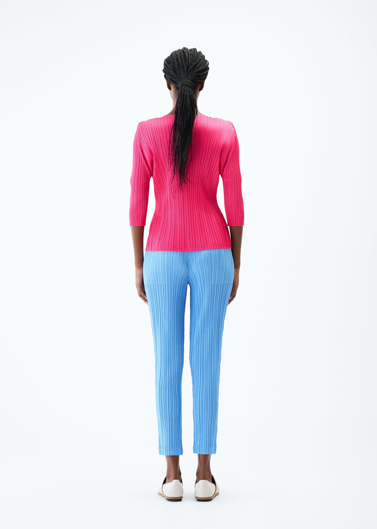 A model wears the PLEATS PLEASE ISSEY MIYAKE THICKER BOTTOMS 2 trousers.