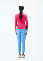 A model wears the PLEATS PLEASE ISSEY MIYAKE THICKER BOTTOMS 2 trousers.